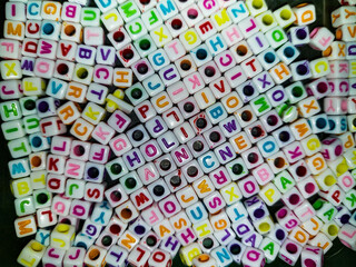 Square-shaped beads with alphabet letters