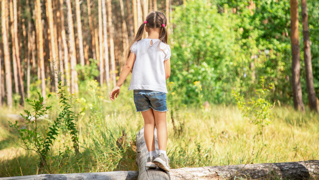 Kid in Forest Walking on Tree Log, Child Playing in Park, Tourist Adventure Girl in forest Children in Camp Trip