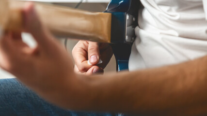 Guitar music. The performer plays. Practice chords. Male performer hands with fingers studying...