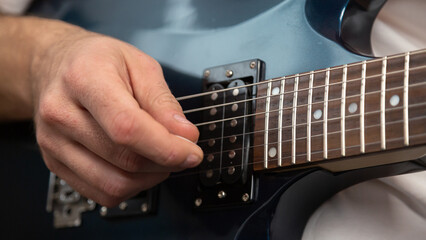 Guitar music. Practice chords. Male performer hands with fingers studying melody of song on...