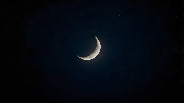 Detailed Crescent Moon in the night sky. Crescent Moon on black background with space for Ramadan theme.