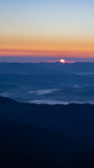 dawn in the mountains, clouds cover the valleys