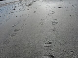 Foot prints on sea side beach background