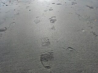 Foot prints on sea side beach background