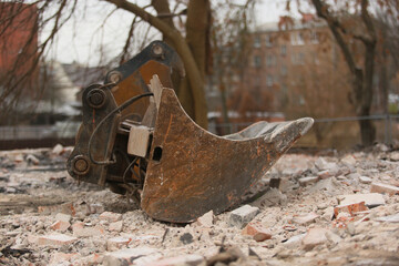Construction equipment: an excavator bucket positioned at a construction site