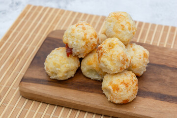 Brazilian cheese bread stuffed with goiabada on a wooden board.