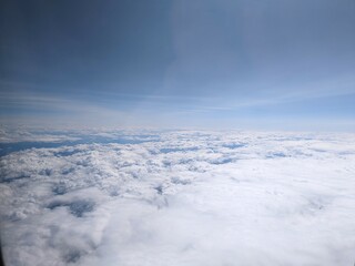 Puffy cumulus clouds from the airplane window