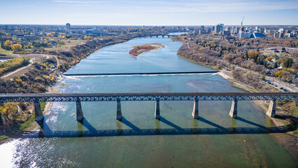 A bridge spans a river, with a train crossing over it