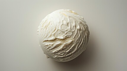 Overhead view of a single scoop of creamy vanilla ice cream.