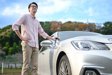 車の前に立つ男性