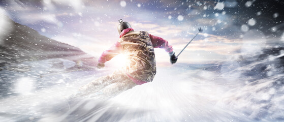 A skier in a ski suit goes down a mountain slope at maximum speed in a snowstorm. Skiing. View from...