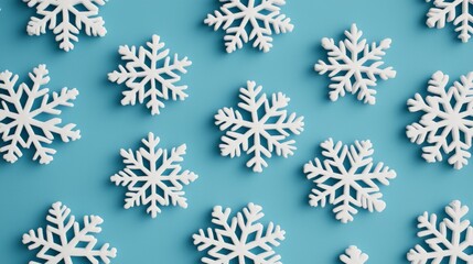 A collection of white snowflakes arranged on a blue background, creating a winter-themed aesthetic.