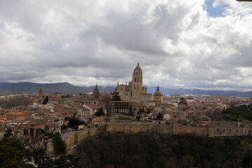 A breathtaking panoramic view of Segovia, highlighting its iconic cathedral standing tall above the...