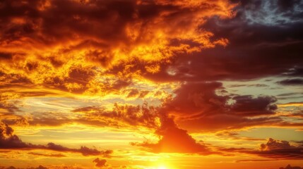 Fototapeta premium Vibrant Sunset Sky with Dramatic Clouds and Golden Hour Light Over Horizon Creating a Serene Nature Background in Summer