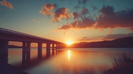 Obraz premium Serene Sunset Reflection Over Bridge and Water Enhancing Tranquil Evening Landscape