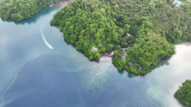 Calm water flows through Lembeh Strait and along the coast of Lembeh Island in North Sulawesi. This tropical area is home to a plethora of marine biodiversity and is popular among divers.
