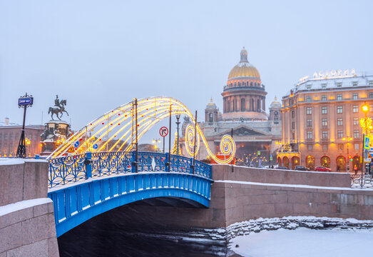 St. Petersburg, Russia – January 03, 2024: New Year’s Petersburg. New Year's decoration of the Blue Bridge against the backdrop of St. Isaac's Cathedral and the Astoria Hotel. New Year holidays - Powered by Adobe