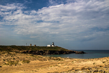 A Mountain Lighthouse Next to a Beach at Cap Angela, Bizerte, Tunisia
