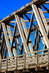 A bridge made of wood with a blue sky in the background