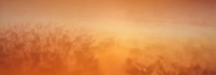 Fototapeta premium Ombre effect created from different shades of orange forming an abstract blurred visual scene, ethereal , ambiance