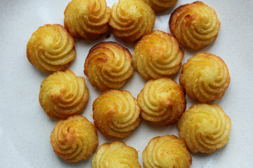 potato kisses on a white plate, close-up.