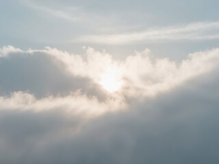 Obraz premium The sky is filled with clouds and the sun is shining through them.