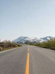 Scenic Road in Jotunheimen National Park with Snowy Mountains and Clear Skies, Norway