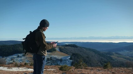 Man exploring mountains, standing on mountain top in Black Forest, South Germany