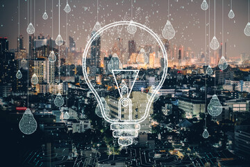 Lightbulb concept overlaying city skyline at night with binary code and light drops.