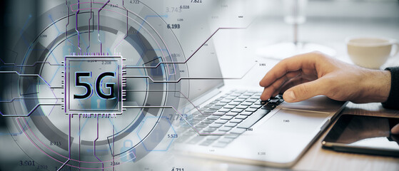 Modern 5G concept with a hand on a laptop keyboard, overlayed with a futuristic digital 5G symbol, on a tech-inspired workspace background.