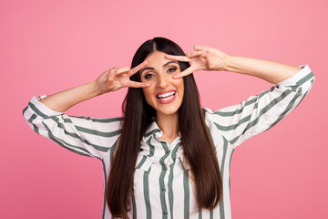 Portrait of young business girl start working day showing victory v sign near eyes greet colleagues...