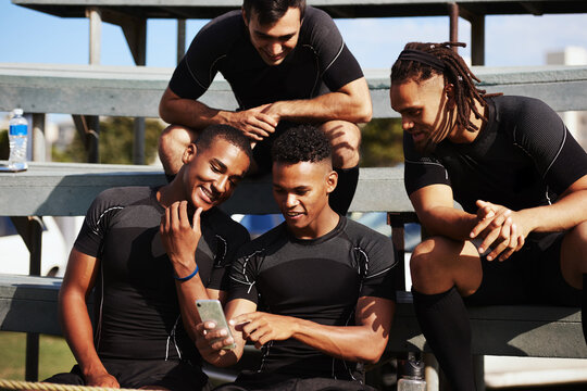 Sports, team men and smartphone for rugby, social media and streaming video for game on stairs. Group of people, players and break with mobile application for match tips, website and smile on field