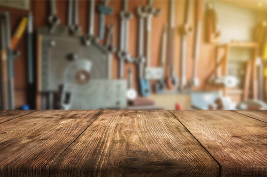Beautiful natural wood tabletop and workshop or garage background with tools