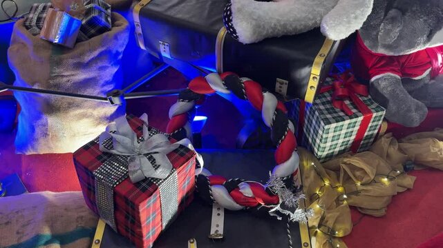 4k footage of christmas decoration of gift boxes, presents, candy cane, teddy bear, hampers, and other kids gift stuffs with wreathes and twinkle or icicle lights.