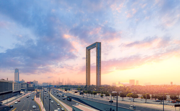 Dubai frame tourist landmark of UAE, United Arab Emirates. Sunset cityscape with skyscrapers
