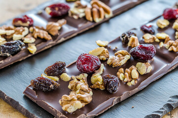 Fototapeta premium Delicious chocolate bark topped with nuts and dried fruits