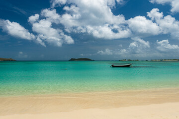 View across the tranquil turquoise lagoon at Carriacou's Paradise Beach to Mabouya Island and Sandy Island on the horizon.