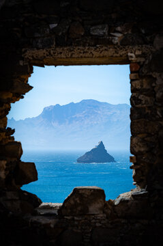 Nice view accross a window opening in the Fortim d'el rei ruins in Mindelo, Cape Verde