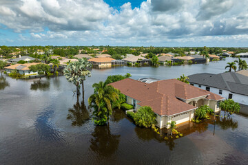 Flooded houses from hurricane rainfall water in Florida residential community. Aftermath of natural...