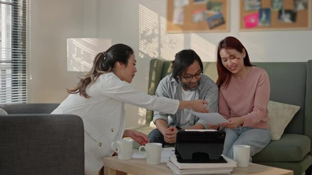 young woman insurance agent analyse financial report of pay attention and paper policy terms conditions to asian couple.Financial advisor,realtor agent,insurance,lawyer,Manage retirement fund concept