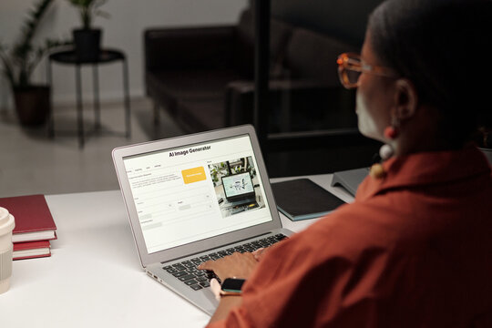 Focus on laptop screen with AI image generator and description of new content while woman typing