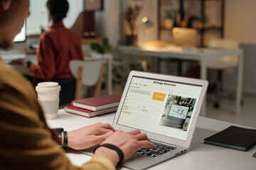 Focus on laptop screen with AI generated image and its description and hands of young businessman typing