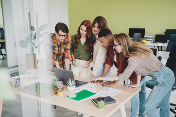 Fototapeta premium Photo of lovely young people teamwork create business strategy startup teambuilding comfortable startup office loft room interior