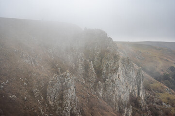 Mysterious atmosphere as fog envelops the steep limestone cliffs of tureni gorge in cluj county, transylvania, romania. (Cheile Turenilor-Tureni )