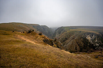 Mystical and serene landscape of turului gorge in cluj county, romania, shrouded in fog on a cold winter day, evoking the beauty of transylvania