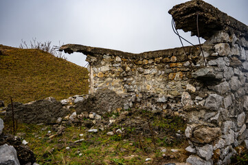 Crumbling stone walls and remnants of a concrete structure stand as testaments to time and decay in turenii's gorge, romania