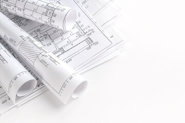 Close-up architect  designer working construction blueprints planning building project.detailed drawings planning tools desk modern workspace.professional project design architecture