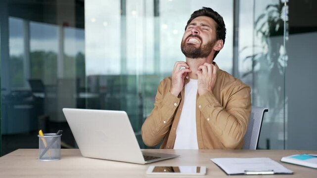 Allergy attack. Itch or pruritus. Businessman scratching suffering from allergic reaction or mosquito bite while sitting at workplace in office. Male has scabies or as result of stress scratches body