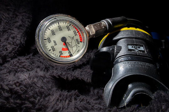 Scuba diving pressure gauge and a second stage air regulator close up. 