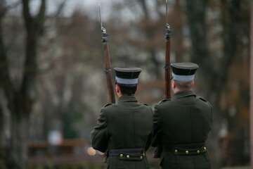 Couple of latvian guards with rifles and bayonets standing in guard in Riga, Latvia